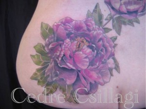 Older tattoo underneath big flower